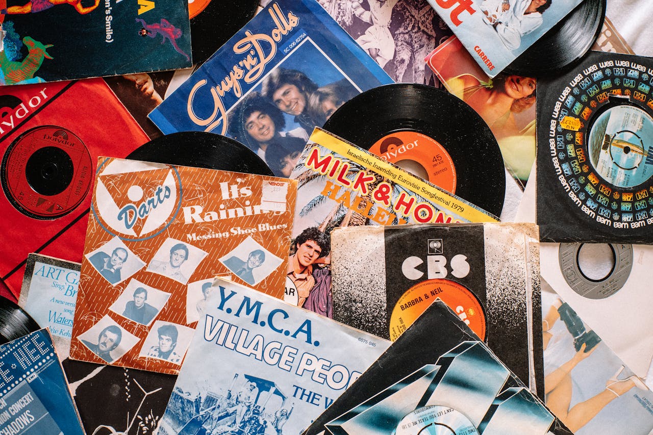 A flat lay of vintage vinyl record covers showcasing 70s and 80s music nostalgia.